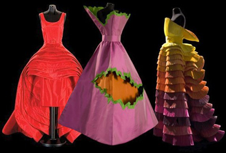 3 capucci dresses on black background